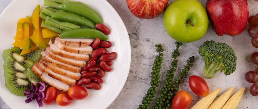 Chicken steak with peas, tomatoes, kiwi and pumpkin. photo