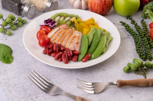 Chicken steak with peas, tomatoes, kiwi and pumpkin. photo