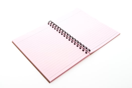 A pink notebook with a spiral bound spiral notebook photo