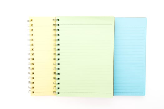 Three notebooks with different colors on a white background photo