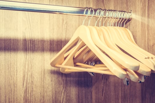 Hangers for clothes hanging on a wooden rack photo