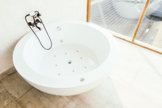 A white bath tub sitting in a room photo