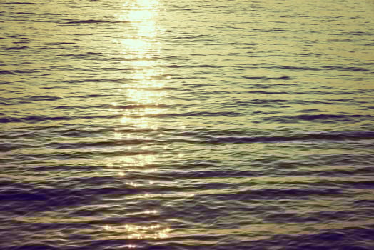 A boat is in the water at sunset photo
