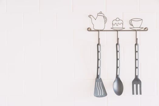 Kitchen utensils hanging on a wall photo