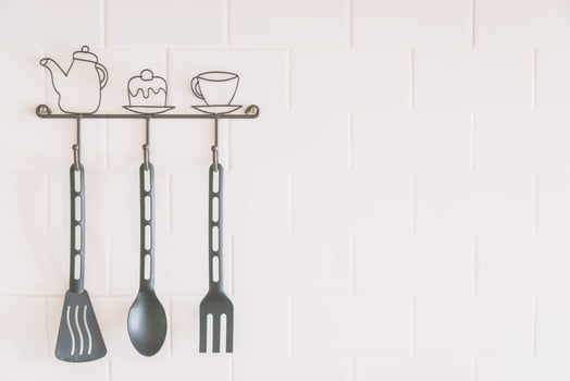 Kitchen utensils hanging on a wall photo