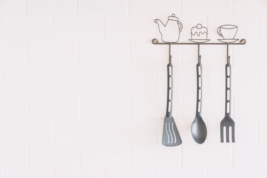 Kitchen utensils hanging on a wall photo