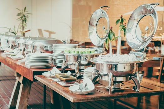 A buffet table with silver dishes and plates photo