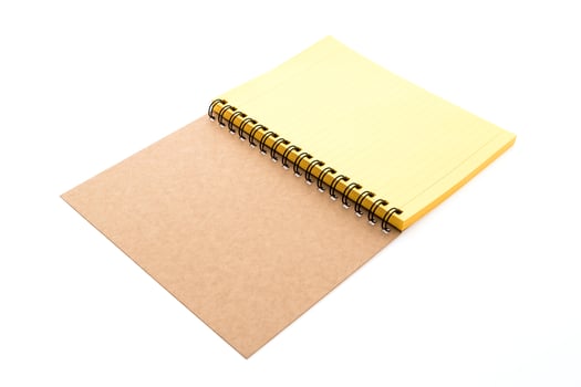 A yellow spiral notebook with a black cover photo