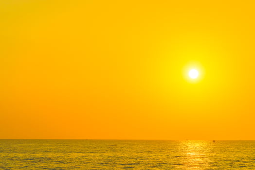 A person is standing on a beach with a surfboard photo