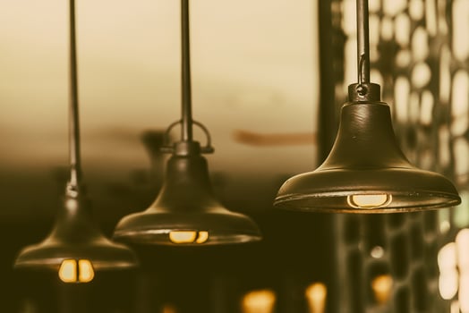 Three light bulbs hanging from a ceiling photo