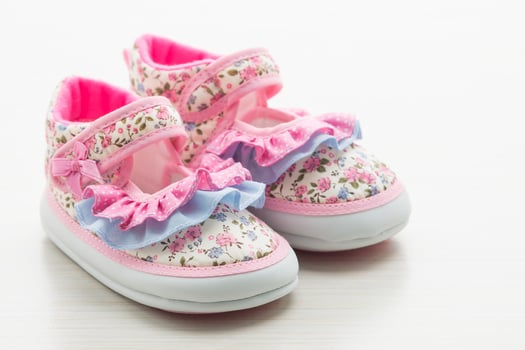 Baby shoes with pink and blue flowers photo