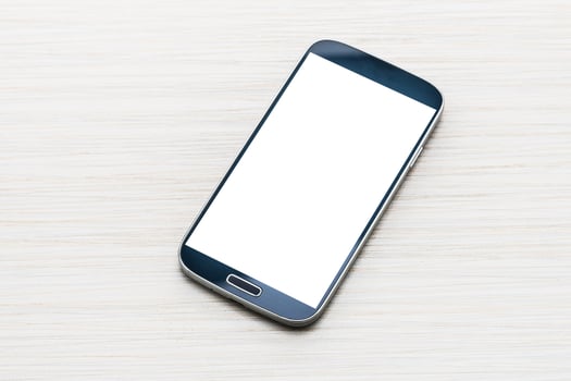 Smartphone with blank screen on wooden background photo