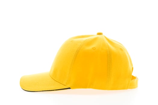 A yellow baseball cap on a white background photo