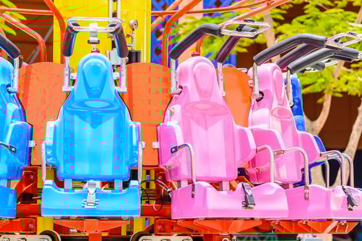 A row of colorful seats on a carnival ride photo