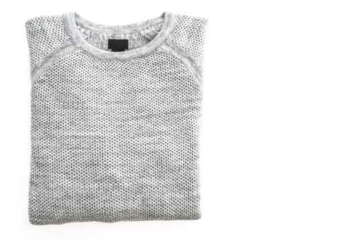 A gray sweater on a white surface photo