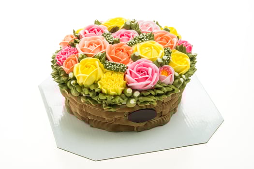 A cake with flowers in a basket on a plate photo