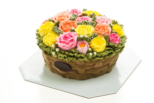 A cake with a basket of flowers on top photo
