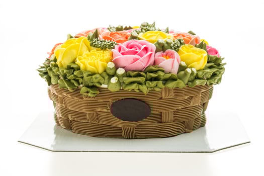 A cake with flowers in a basket on a table photo