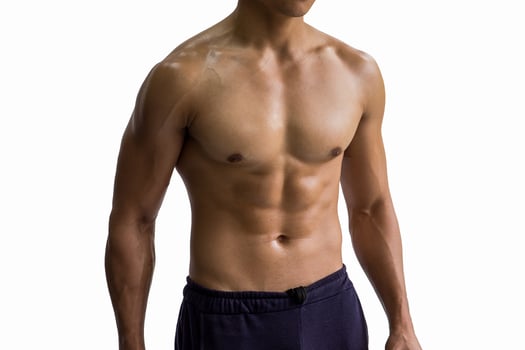 Fitness man showing six pack isolated on white background. photo