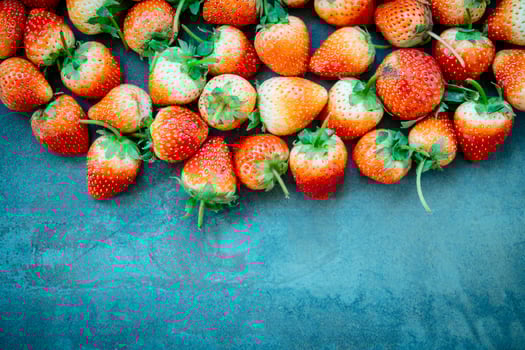 Fresh strawberries on blue background photo