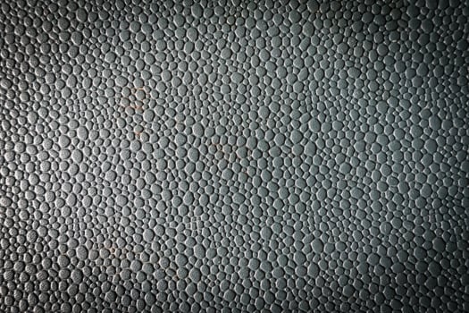 A black leather texture with a few small holes photo
