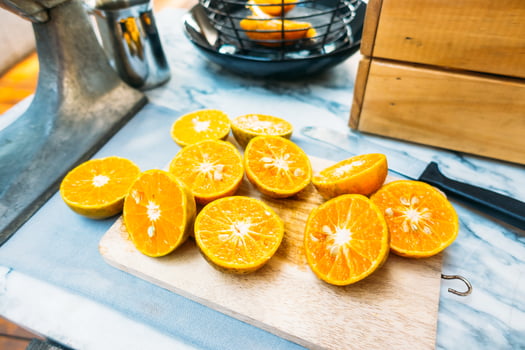 A cutting board with a bunch of oranges on it photo