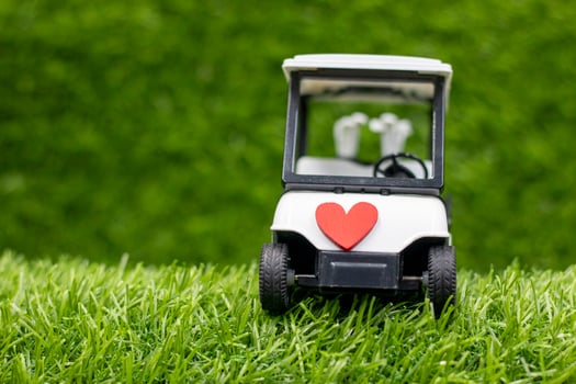 Golf cart is on green grass with love photo