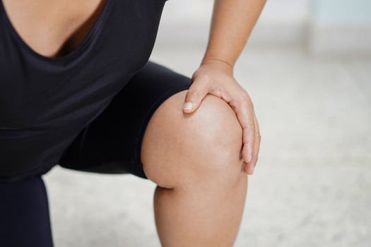 Asian woman pain knee in home photo