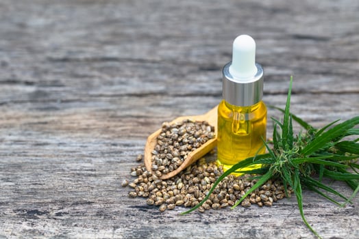 CBD oil hemp products, Medicinal cannabis with extract oil in a bottle on a wooden table. Medical cannabis concept photo