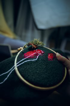 Embroidery process with cotton thread of mushrooms hat. photo