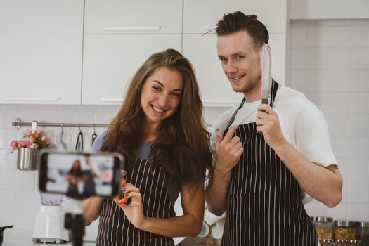 Young Couple Broadcast While Cooking Food photo