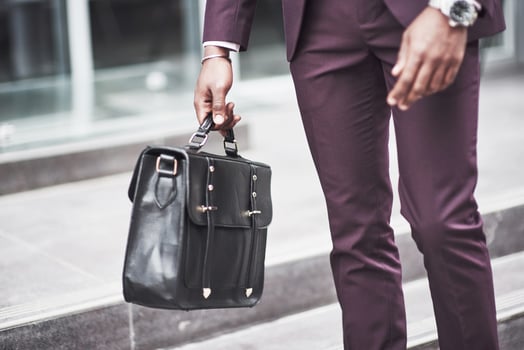 Young businessman with a briefcase near a beautiful office. Business meeting. photo