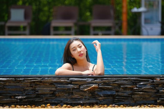 Beautiful southeast asia woman in pool relaxing. photo