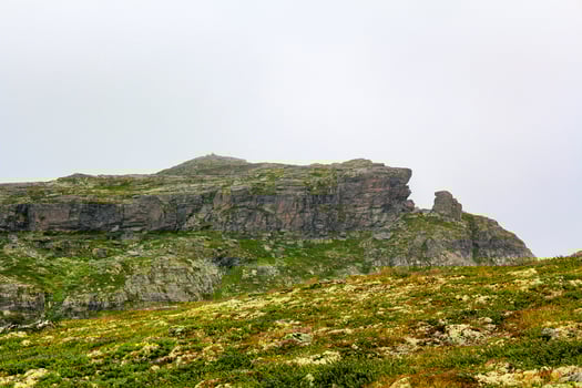 Fog, clouds, rocks, cliffs on peak of Veslehodn Veslehorn. photo