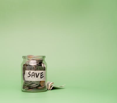 Coins in glass jar with copy space.  Save money concept photo