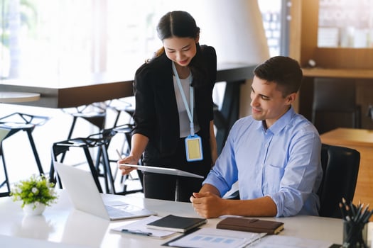 The male marketing manager expressed his satisfaction in selling the company's products. where team members show sales from their iPad screen. photo