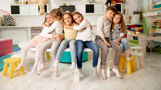 Group of kindergarten kid friends sitting and having fun photo