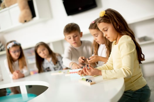 Group of cute little kids playing with preschool educational toys photo