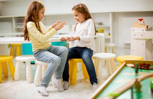 Two best friend girls together in the nursery playroom photo