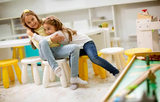 Two best friend girls together in the nursery playroom photo