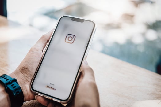 CHIANGMAI, THAILAND, 11-7-21-Man with smartphone with Instagram logo photo