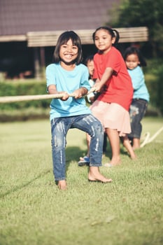 Children group playing tug of war at the park photo