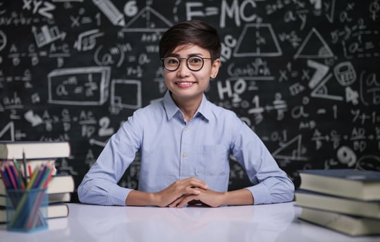 The teacher sat at the table to teach the students in the classroom photo
