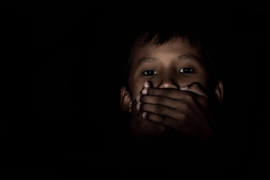 Boy gagged in the dark. photo