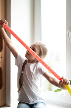 pop tube poptube kid children toy antistress hands holding playing photo