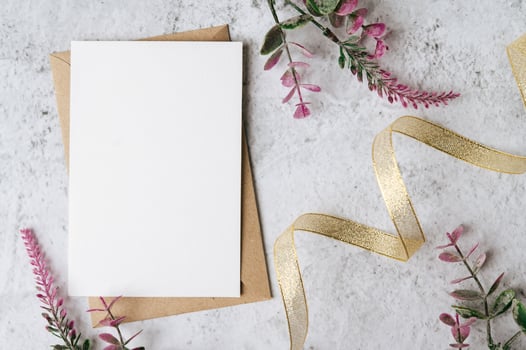 Envelopes and beautiful flowers on marble background photo