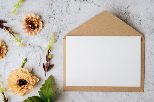 Envelopes and beautiful flowers on marble background photo