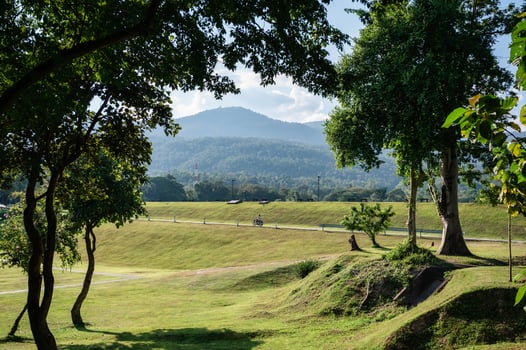 View of green park and mountain on sunny day at Ang Kaew reservoir photo