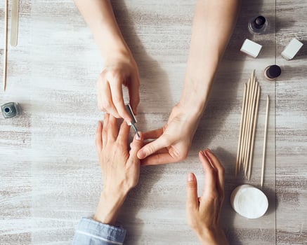Mother and daughter do manicure, paint nails with varnish. Home self-care during quarantine photo