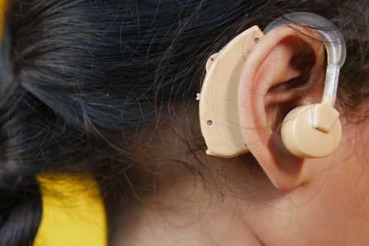 Hearing aid concept, a kid with hearing problems. photo